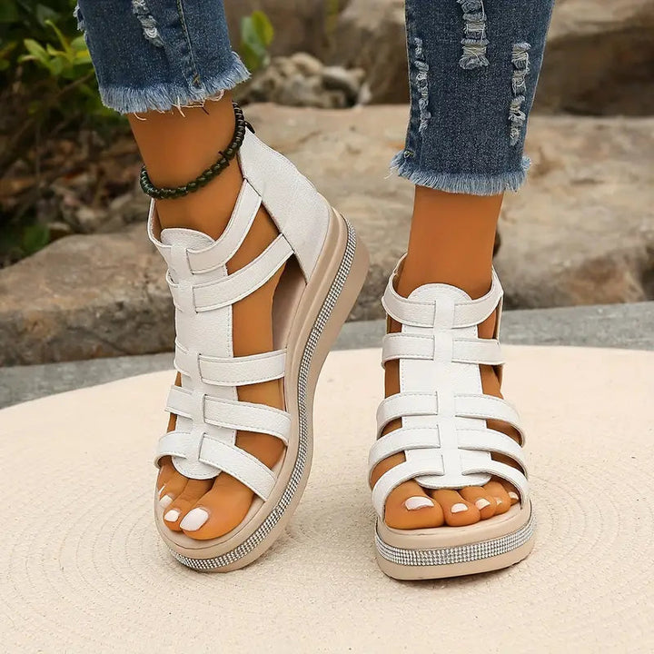 White strappy platform sandal with rhinestone trim and thick sole, front view