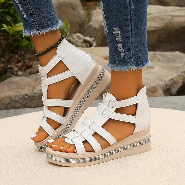 White strappy sandal with rhinestone-embellished platform sole, close-up detail