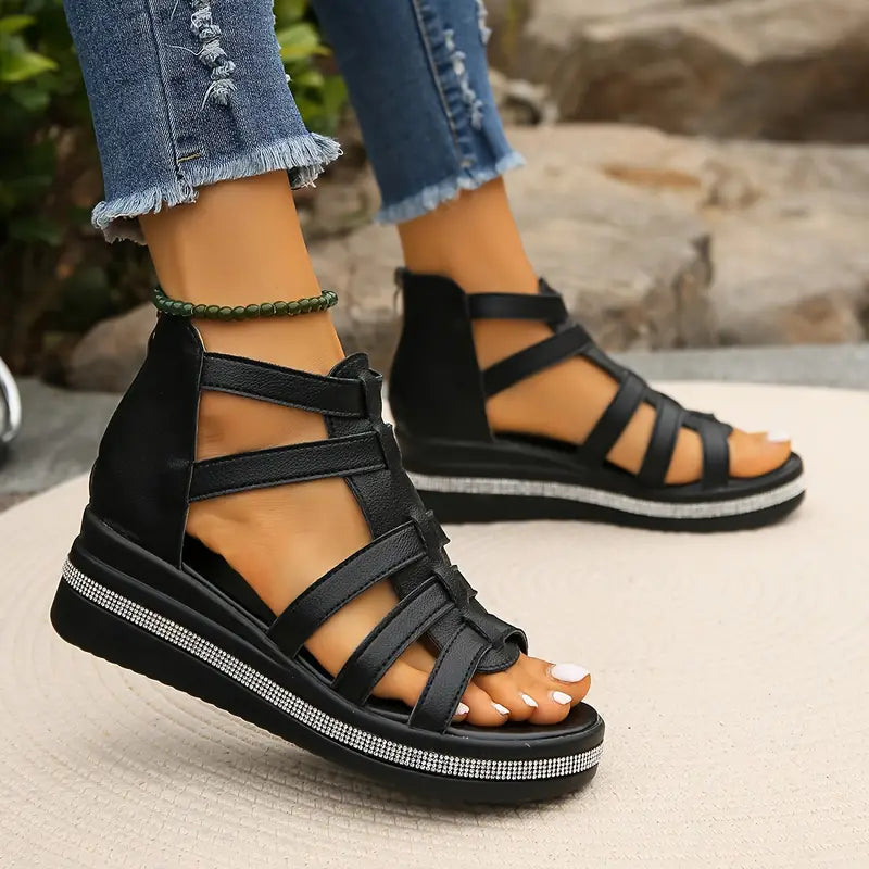 Black strappy platform sandals with rhinestone embellished sole and multiple ankle straps