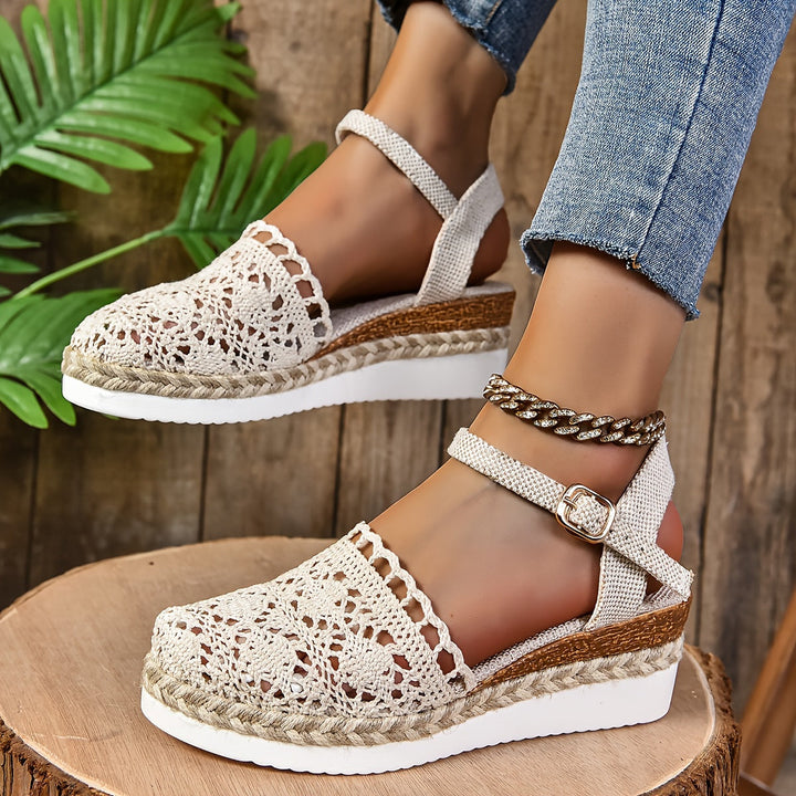 Cream crochet lace sandal with adjustable ankle strap and rope espadrille sole, worn on foot