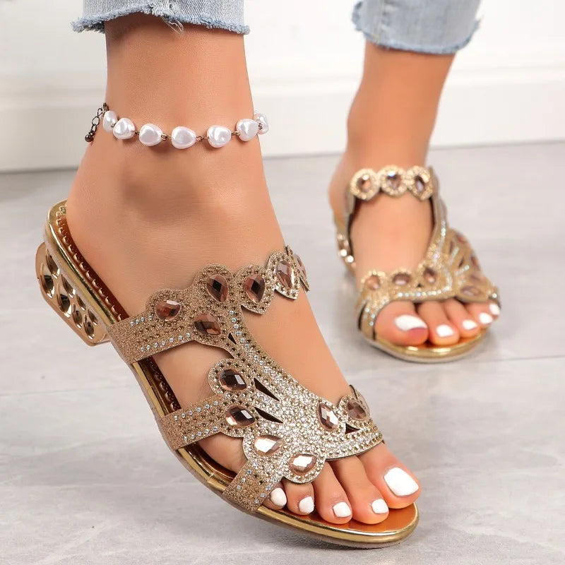 Close-up of gold glitter strappy sandal with crystal embellishments and low chunky heel