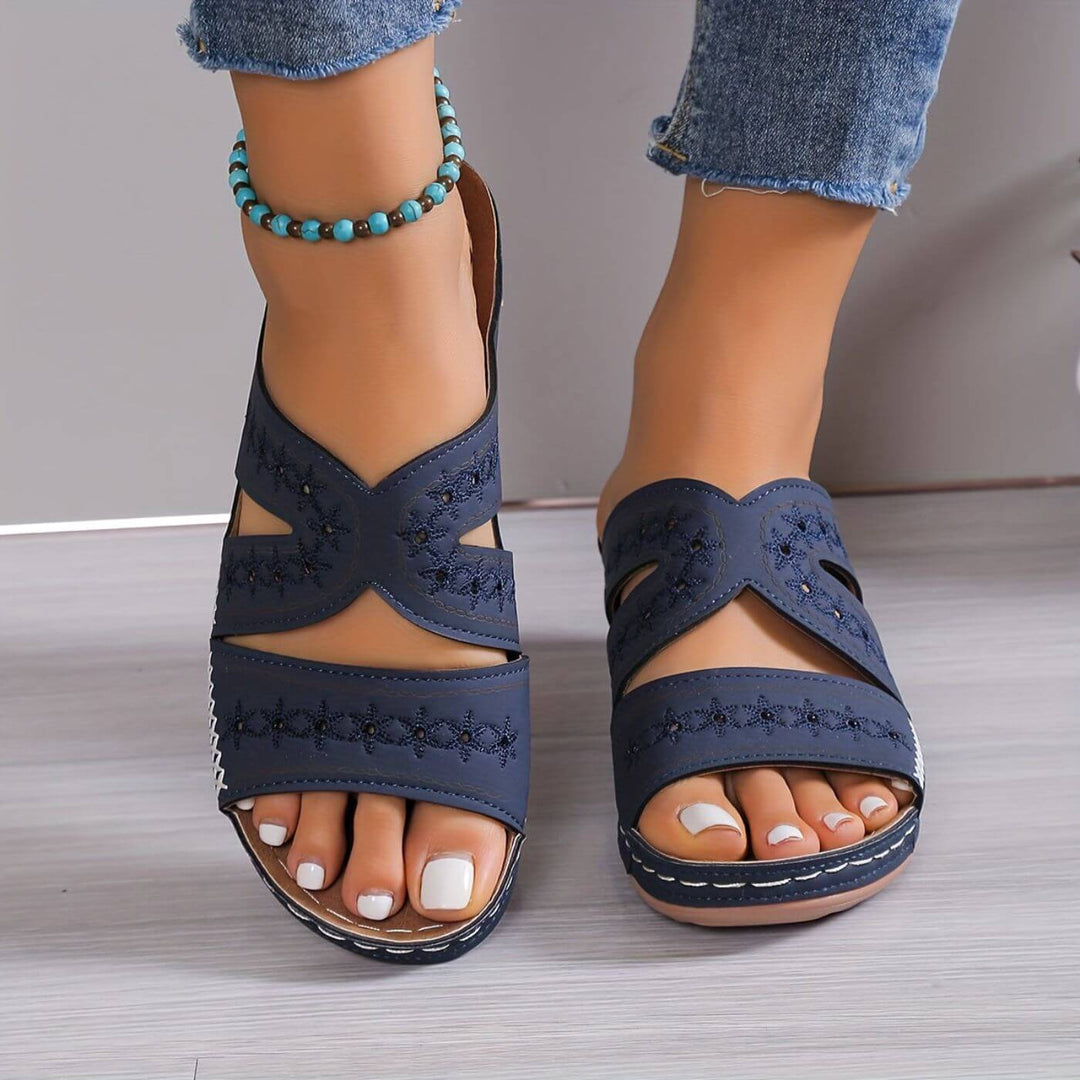 Navy blue embroidered orthopedic sandals with crossover straps and white topstitching