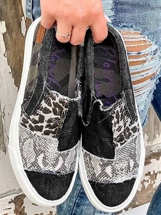 Overhead view of black and gray leopard mixed print canvas slip-on sneakers