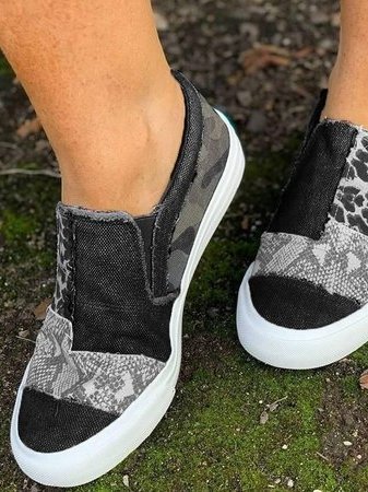 Side view of women leopard print canvas slip-on sneaker with white sole