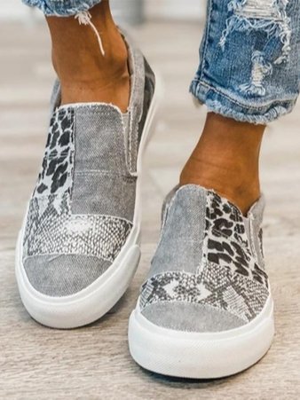 Beige canvas slip-on sneakers with leopard print accent and white rubber sole