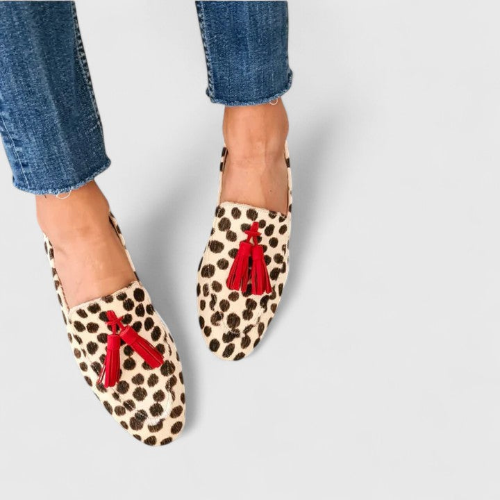 Women leopard print loafers with red tassel detail on cream and brown spotted upper