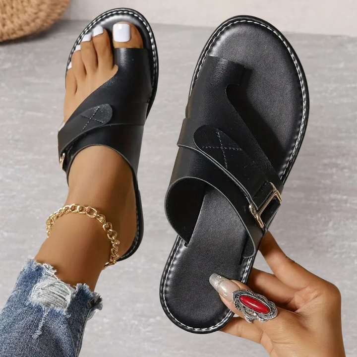 Black orthopedic cross strap sandal with cushioned sole and adjustable ankle strap