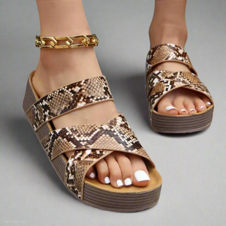 Snakeskin print crossover strap platform sandal with gold chain ankle bracelet