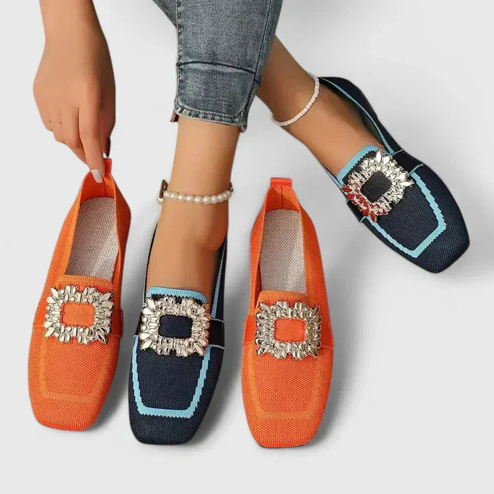 Ruffled trim loafers in navy, orange, and black with decorative bows displayed