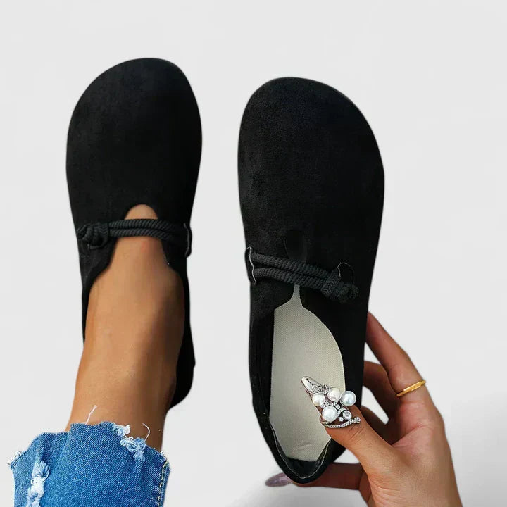 Black suede slip-on loafer flats with rope trim detail, front and back view