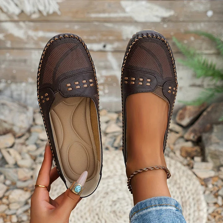 Dark brown perforated moc toe loafer flats with cushioned footbed, overhead view