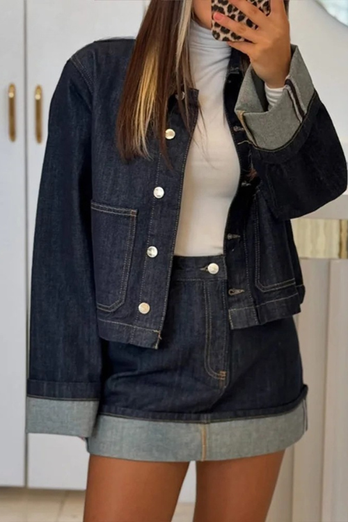 Women dark wash denim cropped jacket with silver buttons and mini skirt, full body view.