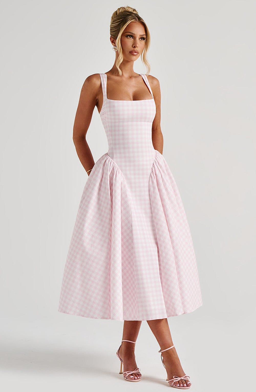 Women pink gingham midi dress side view with voluminous skirt and square neckline