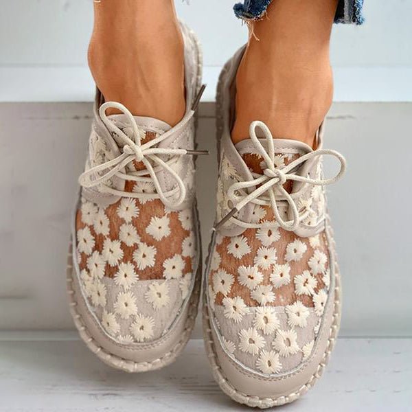 Women's beige floral embroidered lace-up sneakers with braided sole, front view