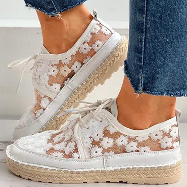 Women's white floral embroidered lace-up sneakers with braided espadrille sole, side view