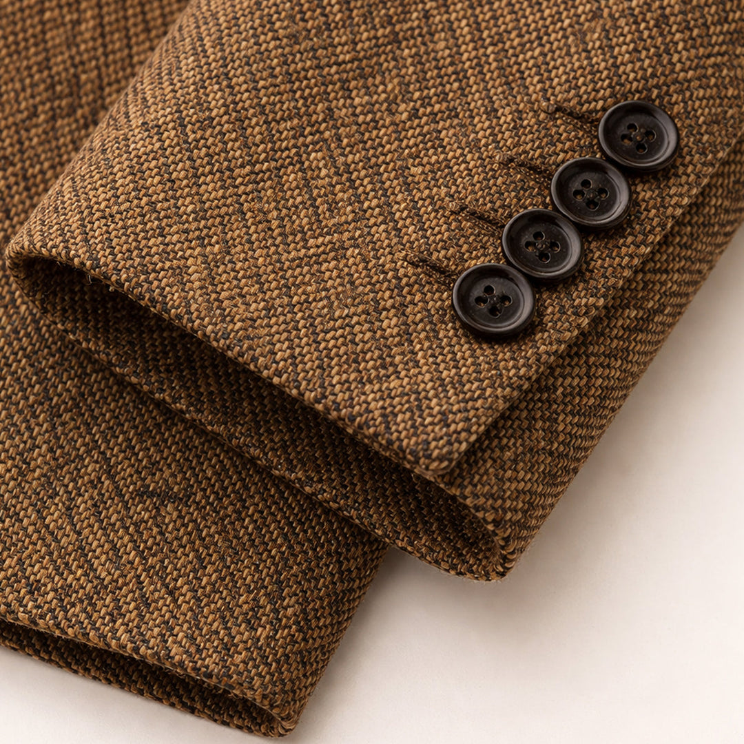 Sleeve cuff detail showing four black buttons on tan herringbone blazer