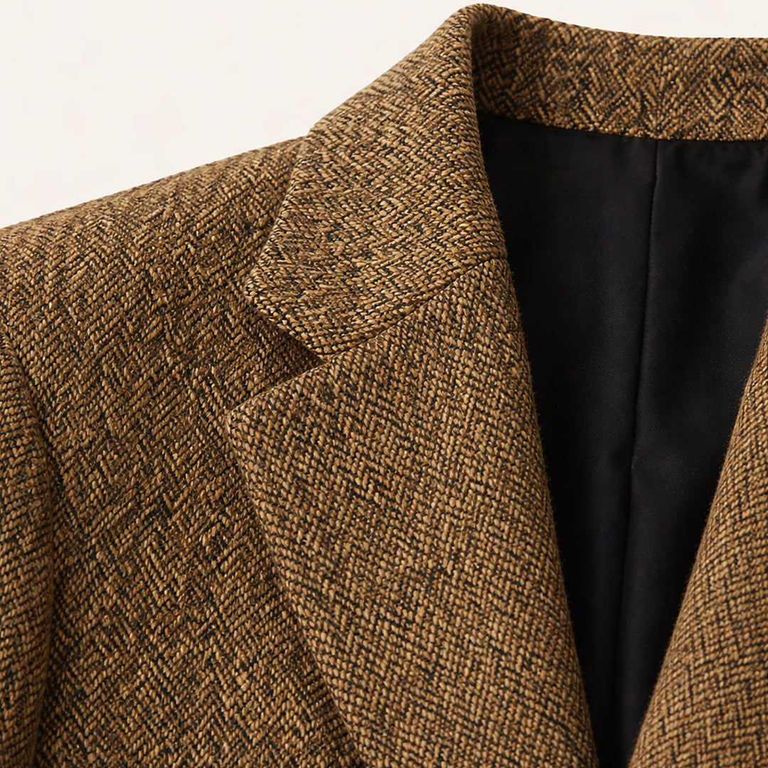 Close-up of tan herringbone wool texture and black interior lining