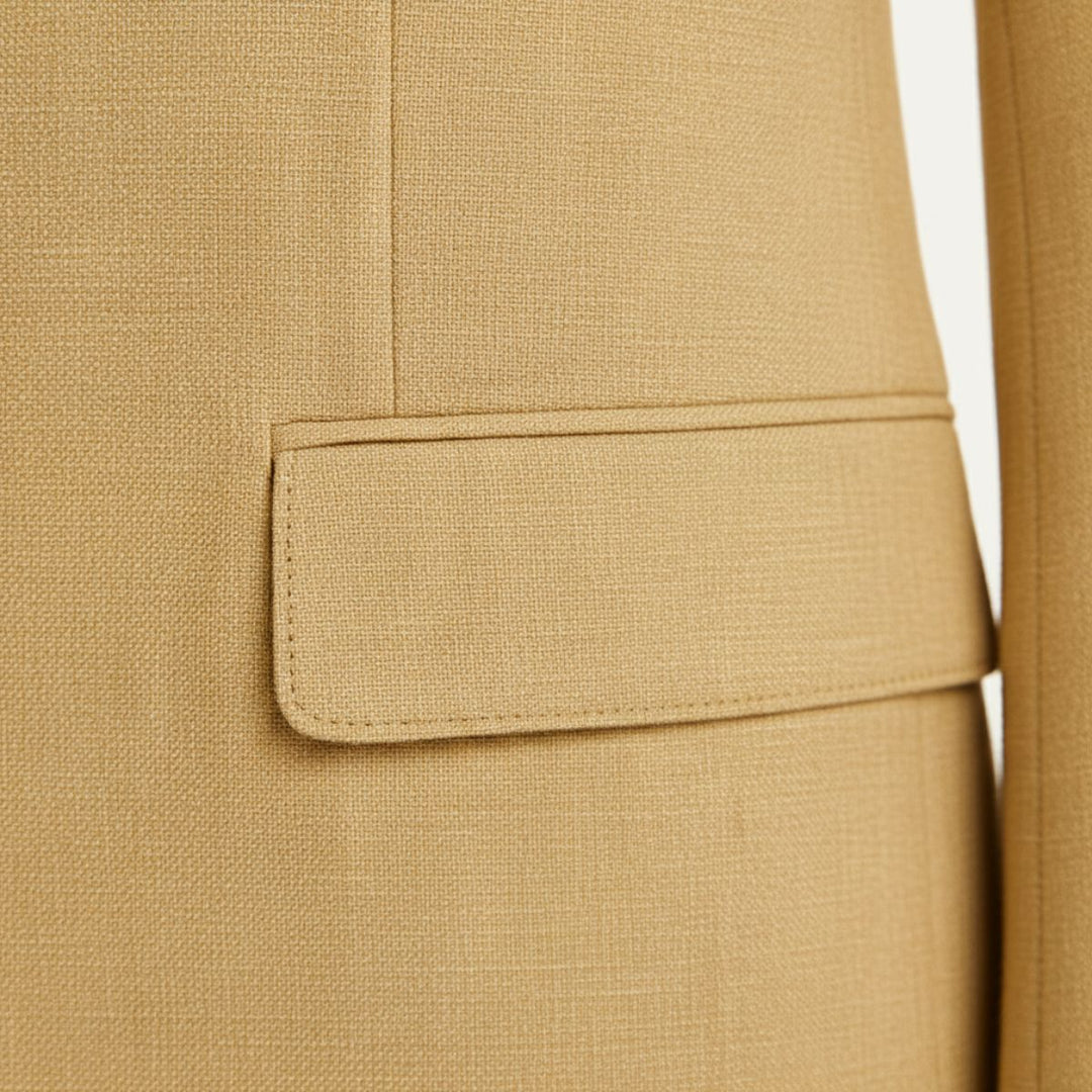 Tan linen blazer pocket detail showing tailored welt pocket on jacket