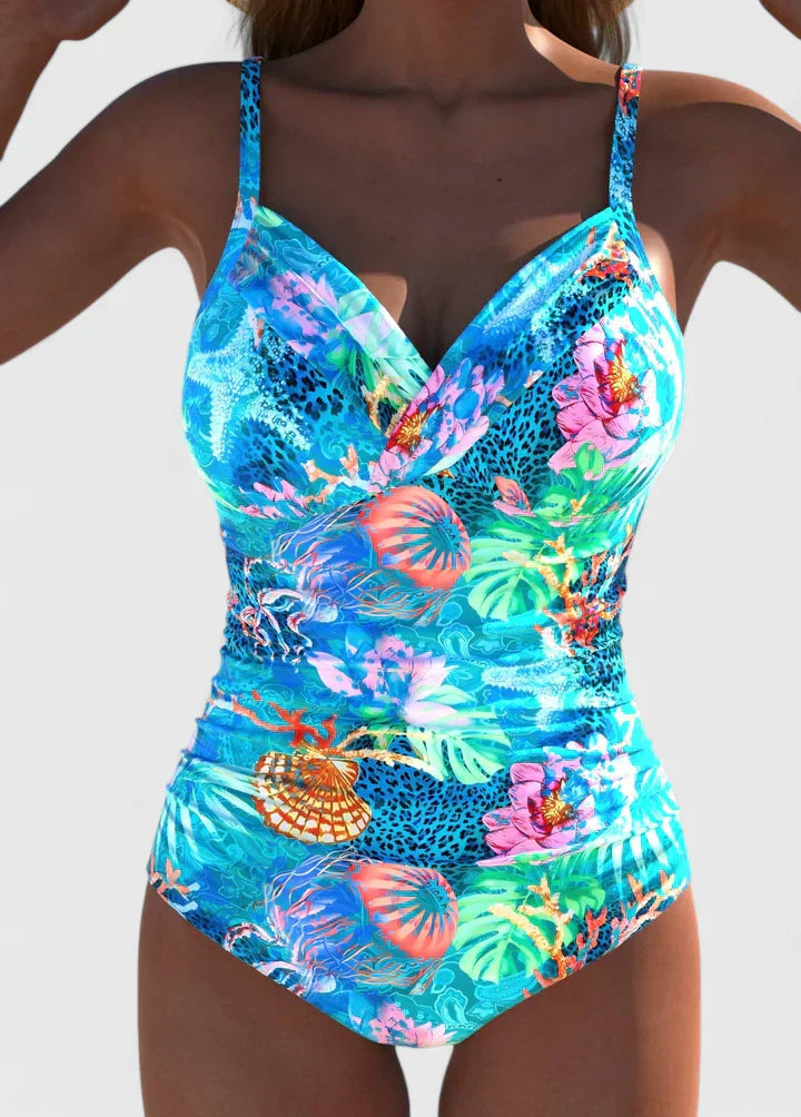 Tropical printed one-piece swimsuit with colorful ocean and botanical design, front detail view