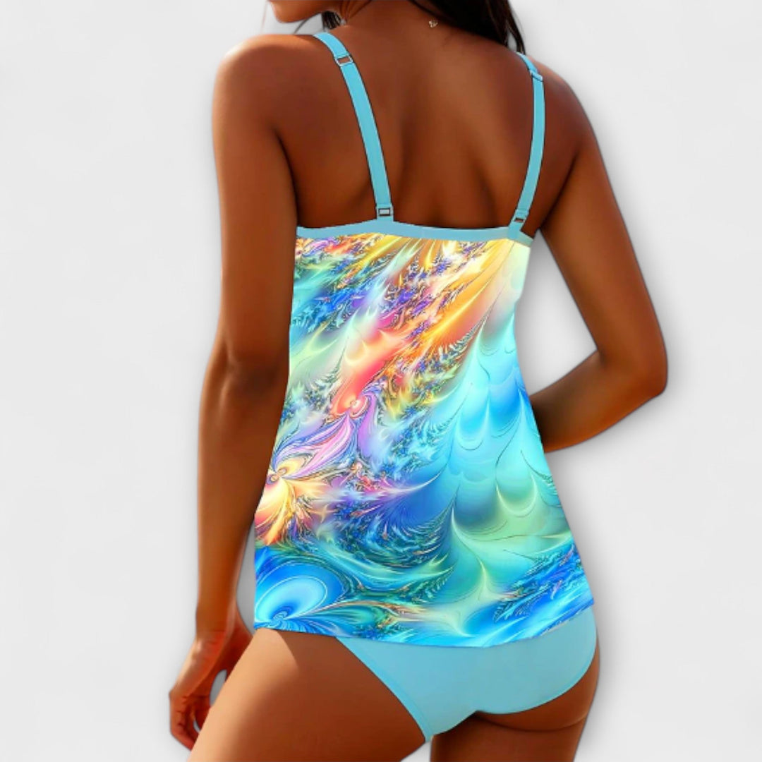 Back view of colorful printed tankini swimsuit with turquoise straps and solid turquoise bottoms