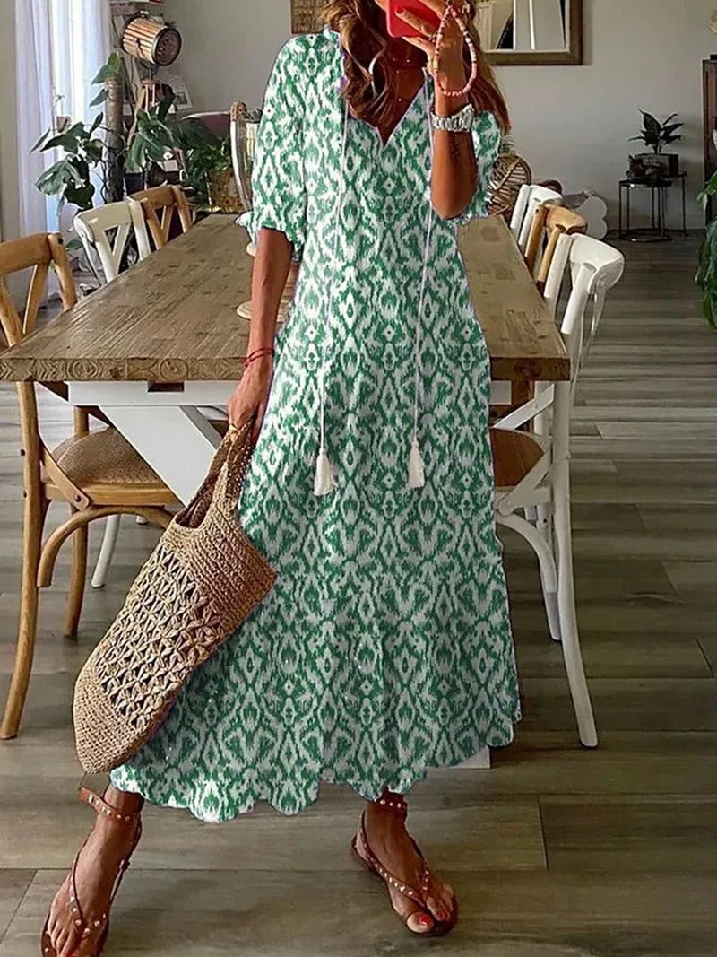 Women green patterned maxi dress with V-neckline and short sleeves, side view indoors